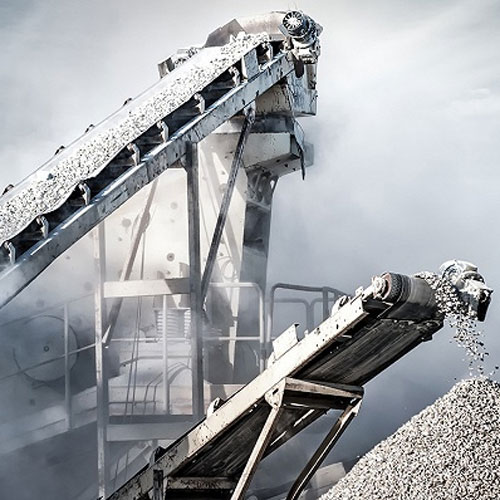 person using crane to move industrial gear box in engineering factory